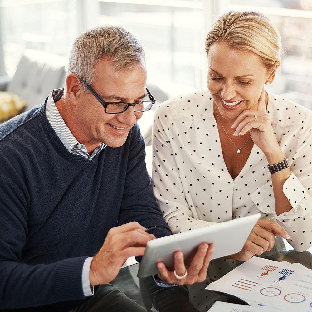 couple smiling while planning their finances